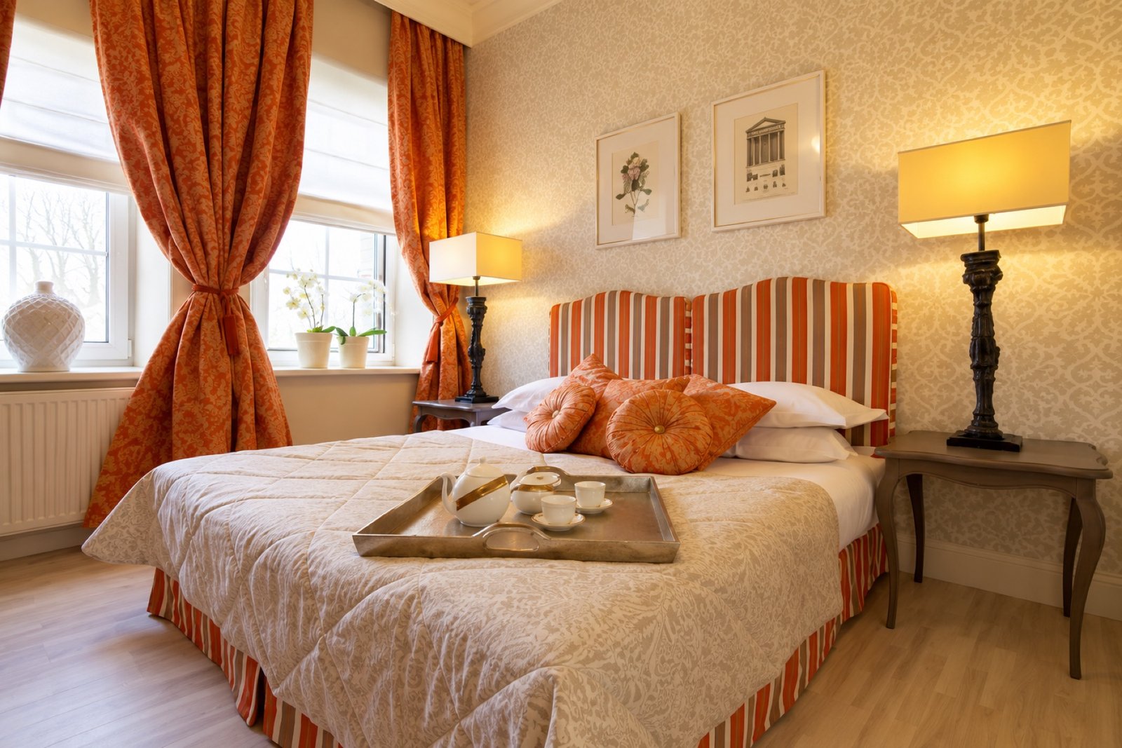 A warm amber bedroom with striped upholstery